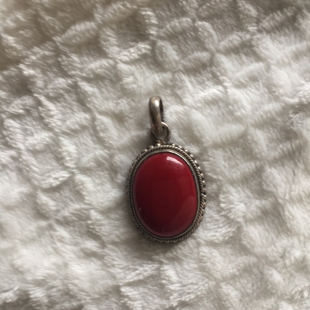 Red stone and silver pendant